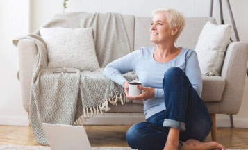 woman sitting on the floor drinking coffee