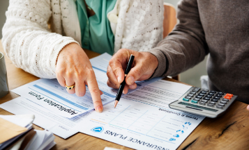 elderly couple meeting with insurance agent