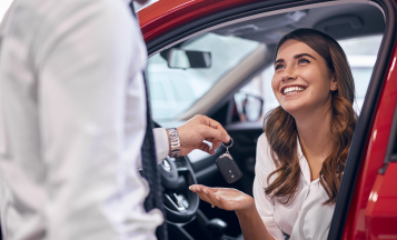 woman getting the keys to a new car